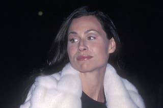 A photo of Minnie Driver in a white fur coat at a nighttime event