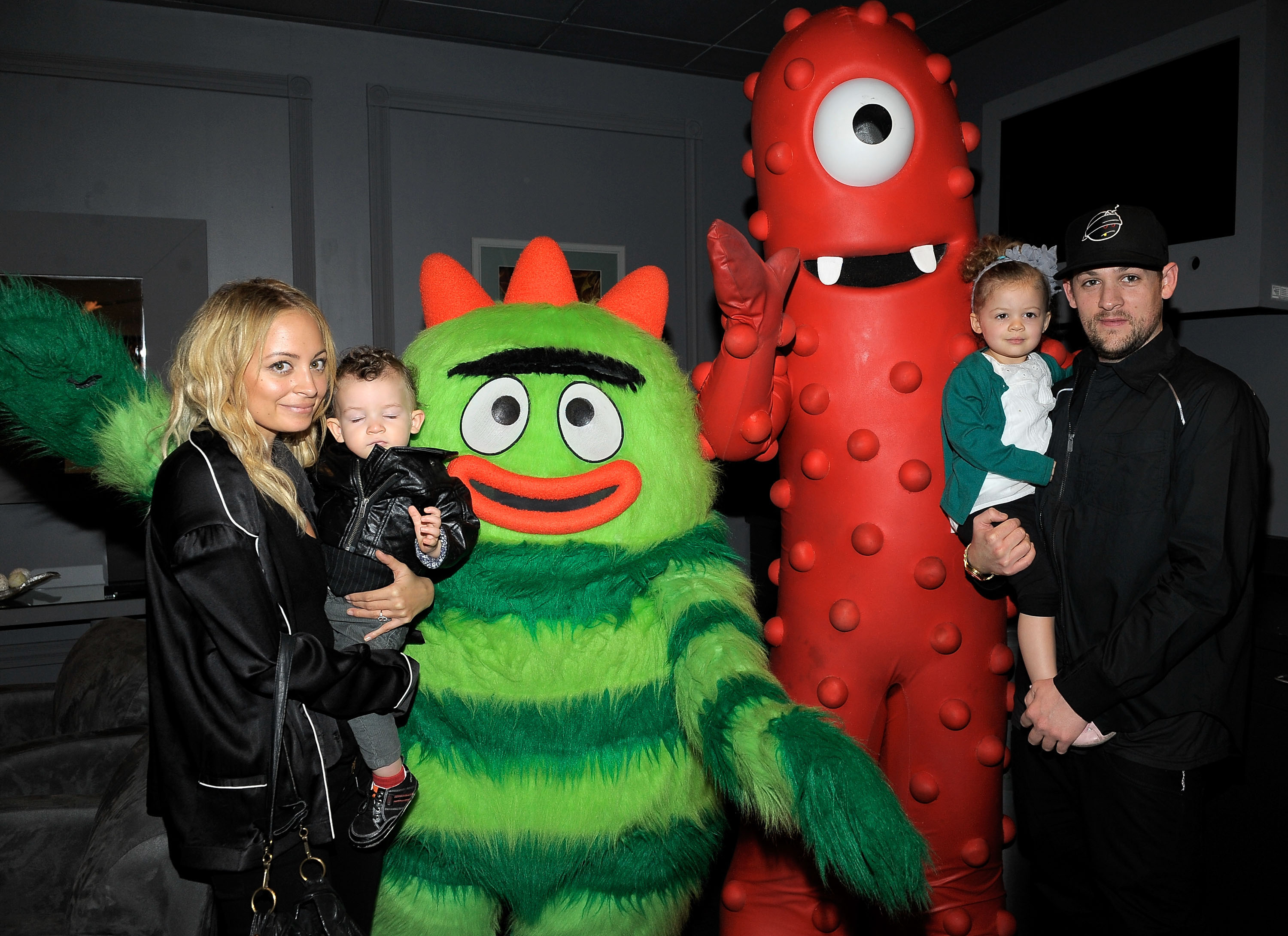 A family poses with costumed characters from the children&#x27;s show &#x27;Yo Gabba Gabba!&#x27; at an event