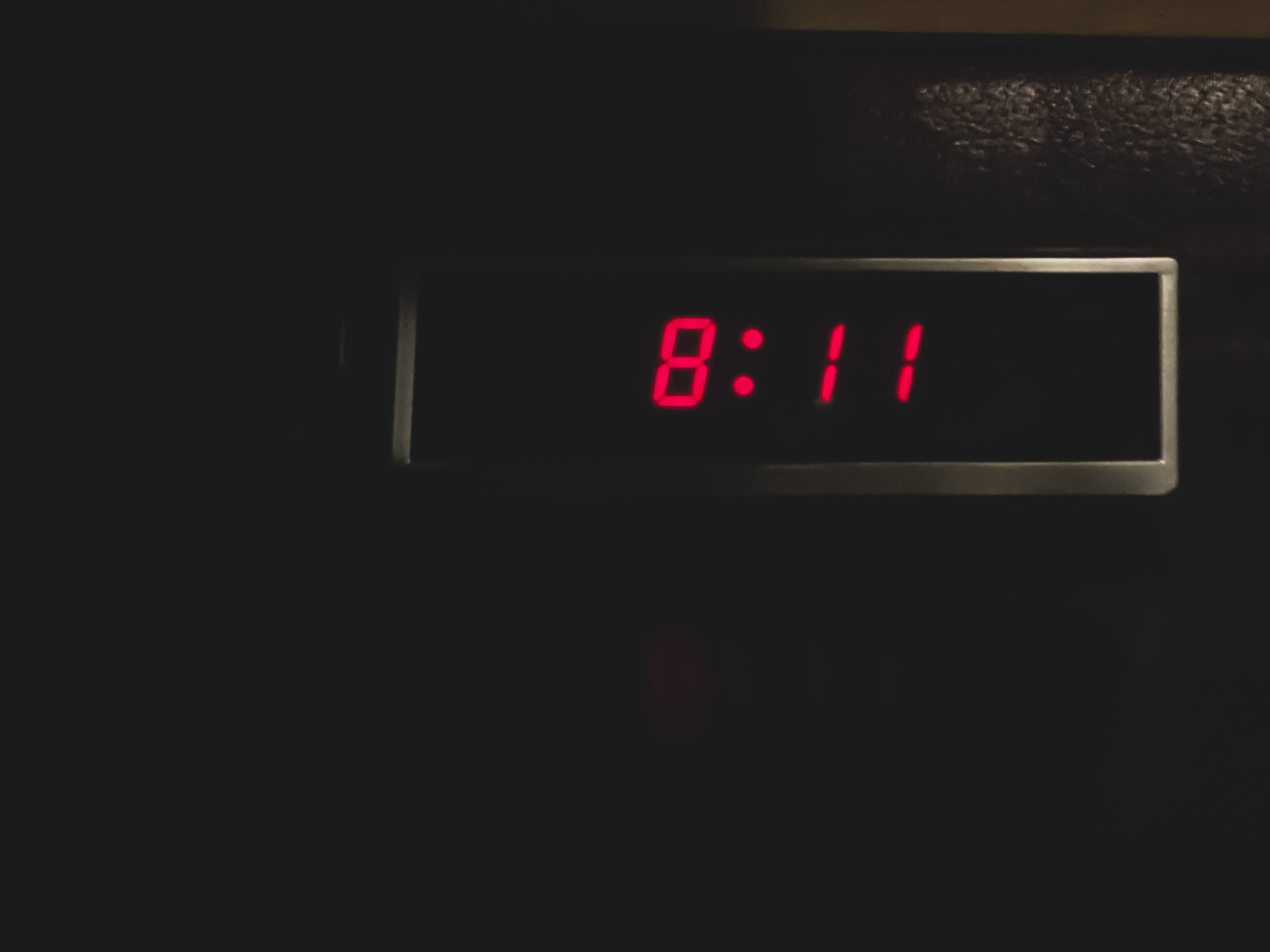 Digital clock displaying the time 8:11 in a dark setting