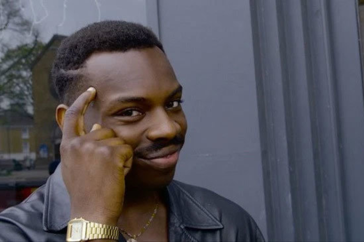 Man pointing to his head with a knowing smile