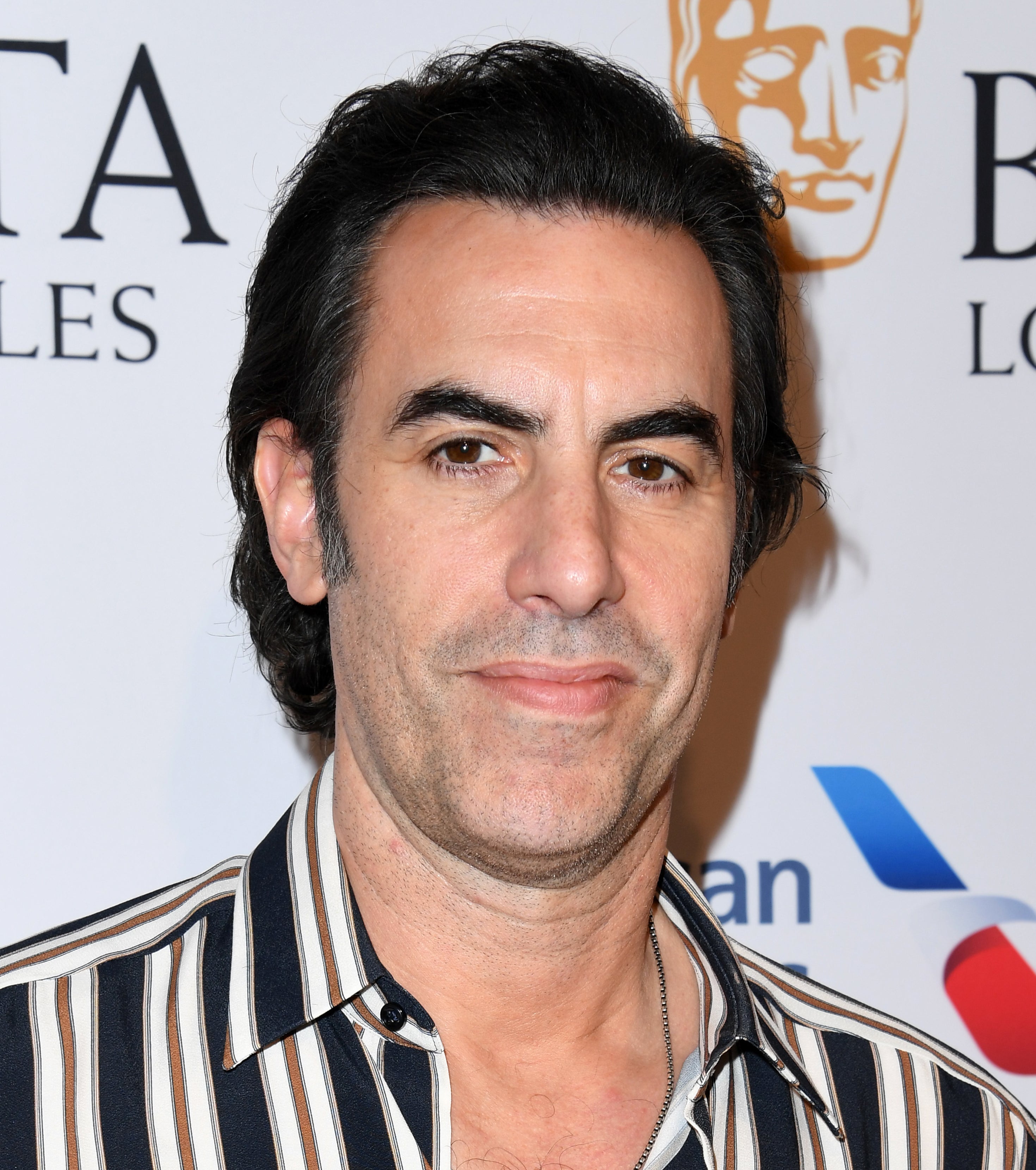Sacha Baron Cohen in striped shirt on the red carpet