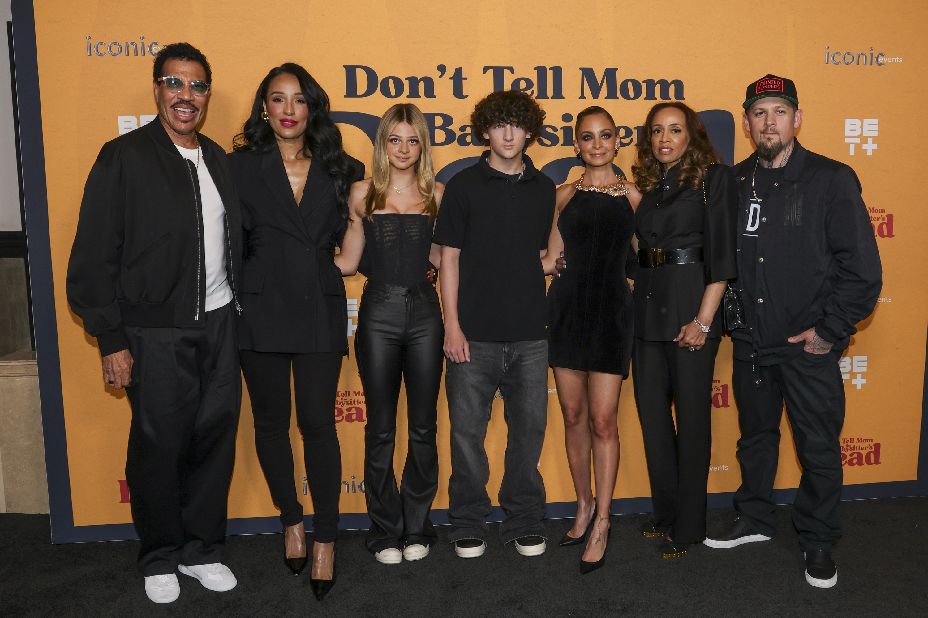 Six people posing together at the &quot;Don&#x27;t Tell Mom&quot; event; two men and four women, with a mix of casual and formal attire