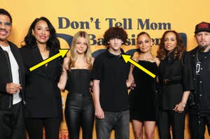Group photo of cast members at 'Don't Tell Mom' premiere, two individuals wearing black highlighted