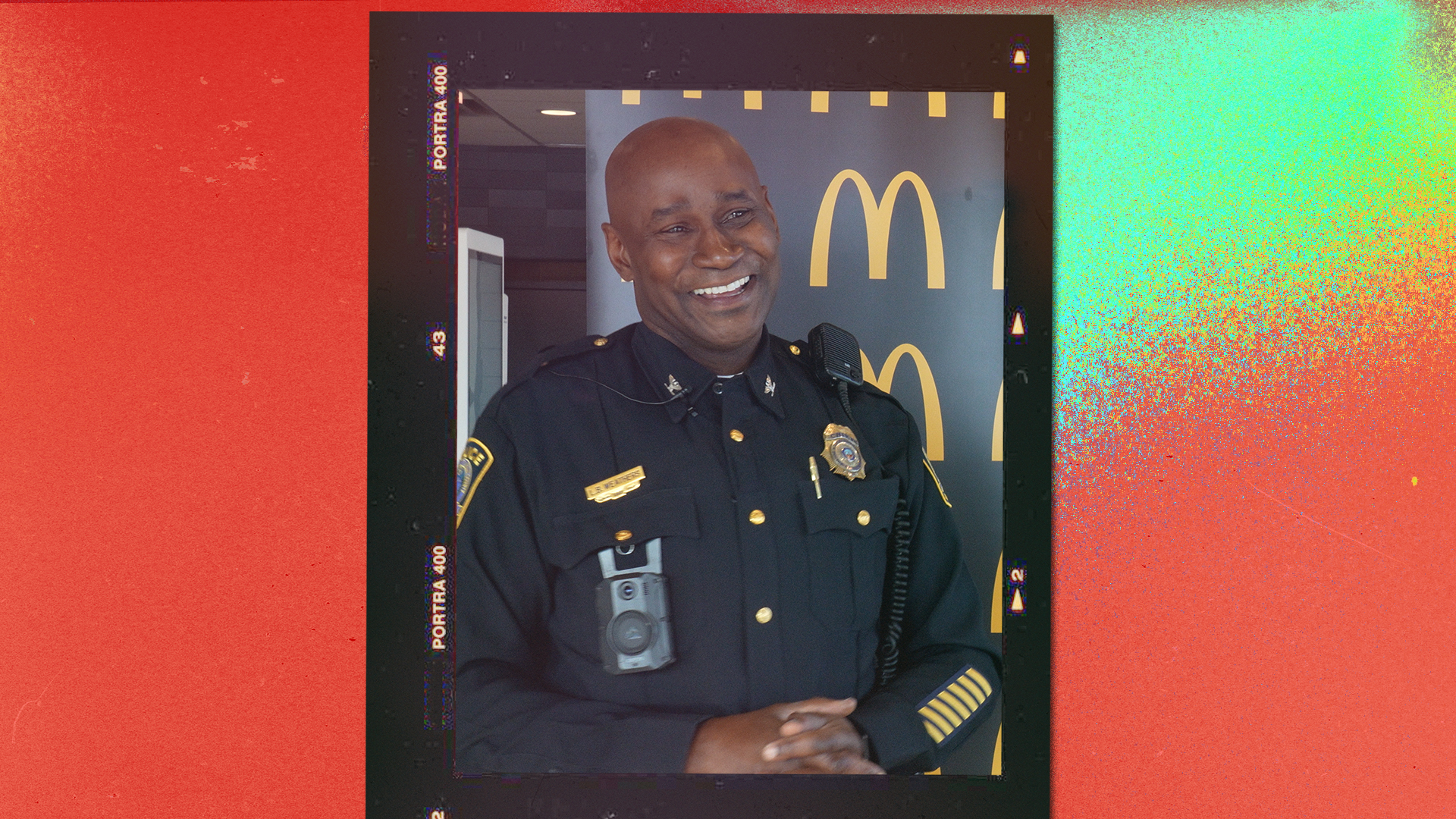 Smiling police officer standing inside a McDonald&#x27;s restaurant