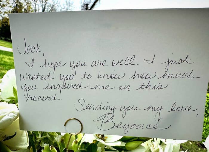 Handwritten note from Beyoncé expressing inspiration for a record, with flowers and ring in the background
