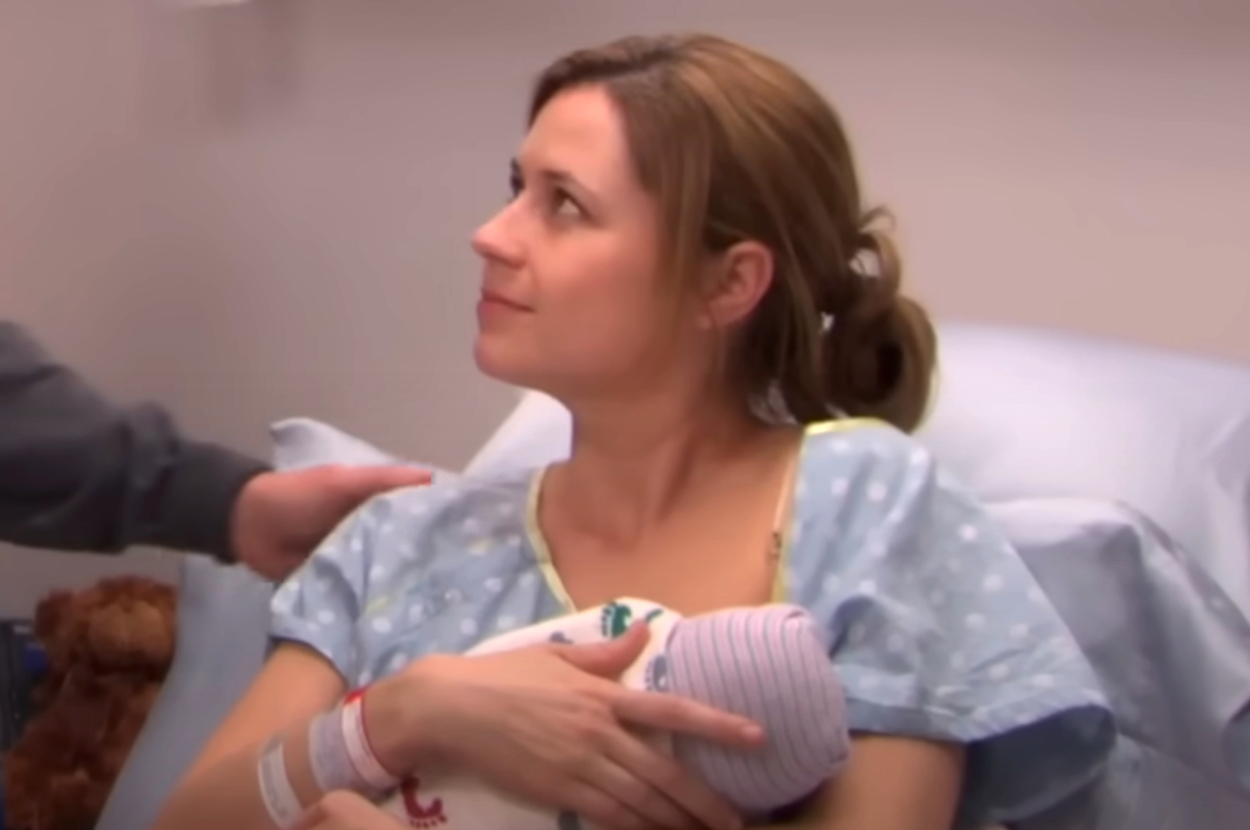 Pam from The Office holding a baby