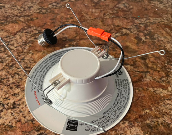 Smoke detector with mounting bracket and wiring connectors on a surface