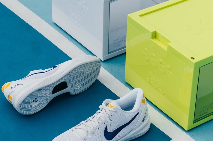 Close-up of Nike sneakers next to their boxes on a textured surface