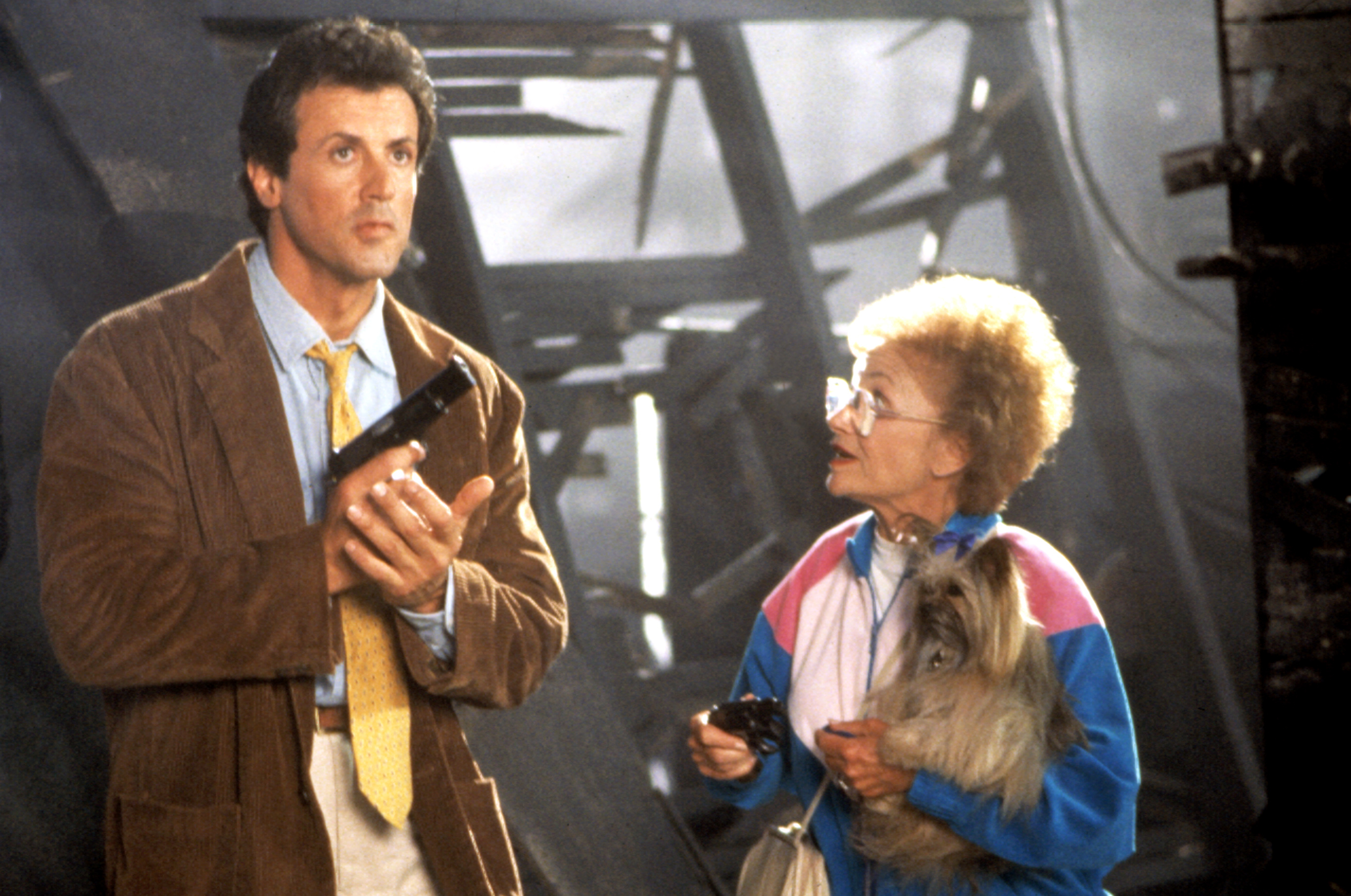 Two characters from Back to the Future, Marty&#x27;s parents, with a dog, look surprised in a scene