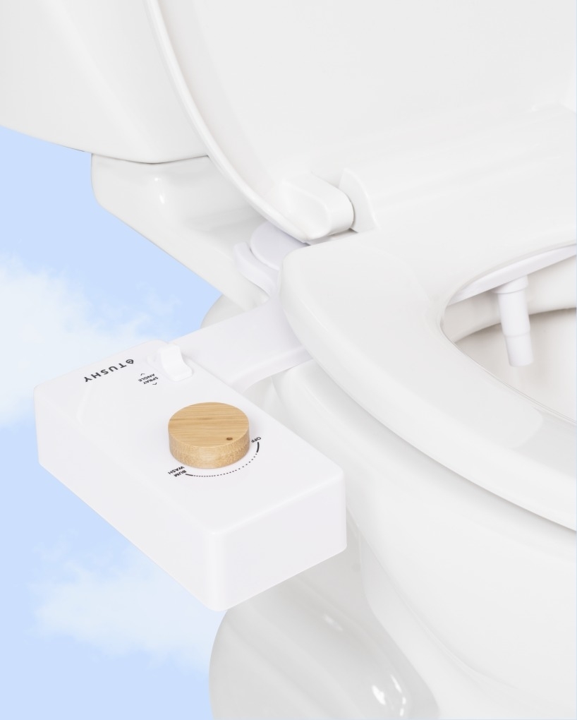 Bidet on toilet seat with a bamboo knob