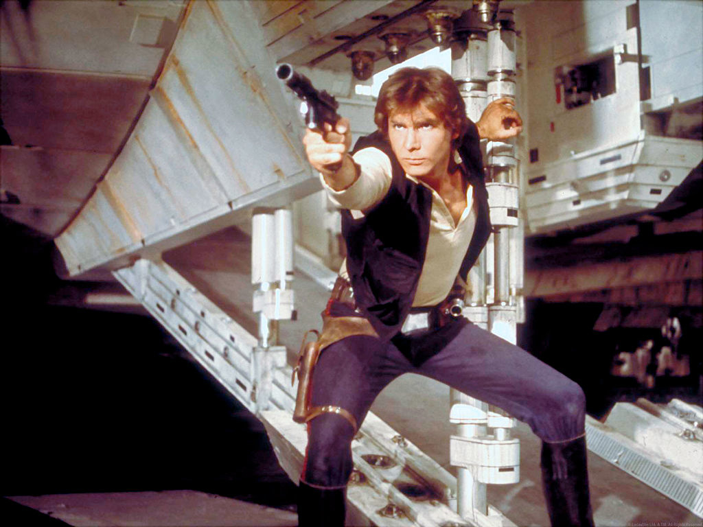 Han Solo in action pose with blaster inside a spacecraft