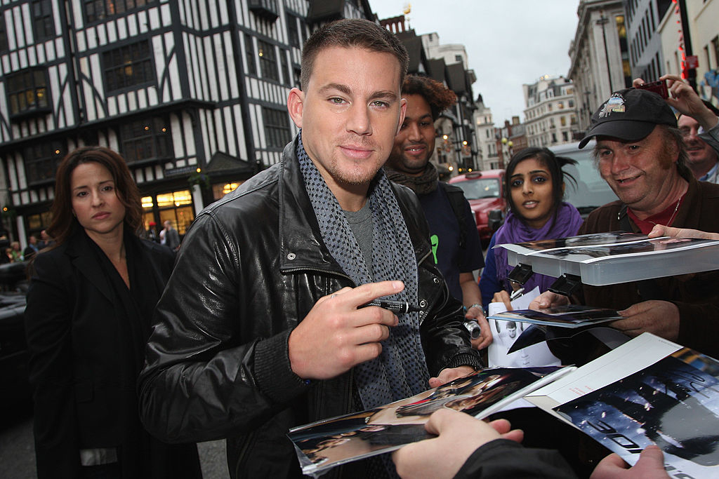 Channing Tatum in leather jacket signing autographs for fans on the street