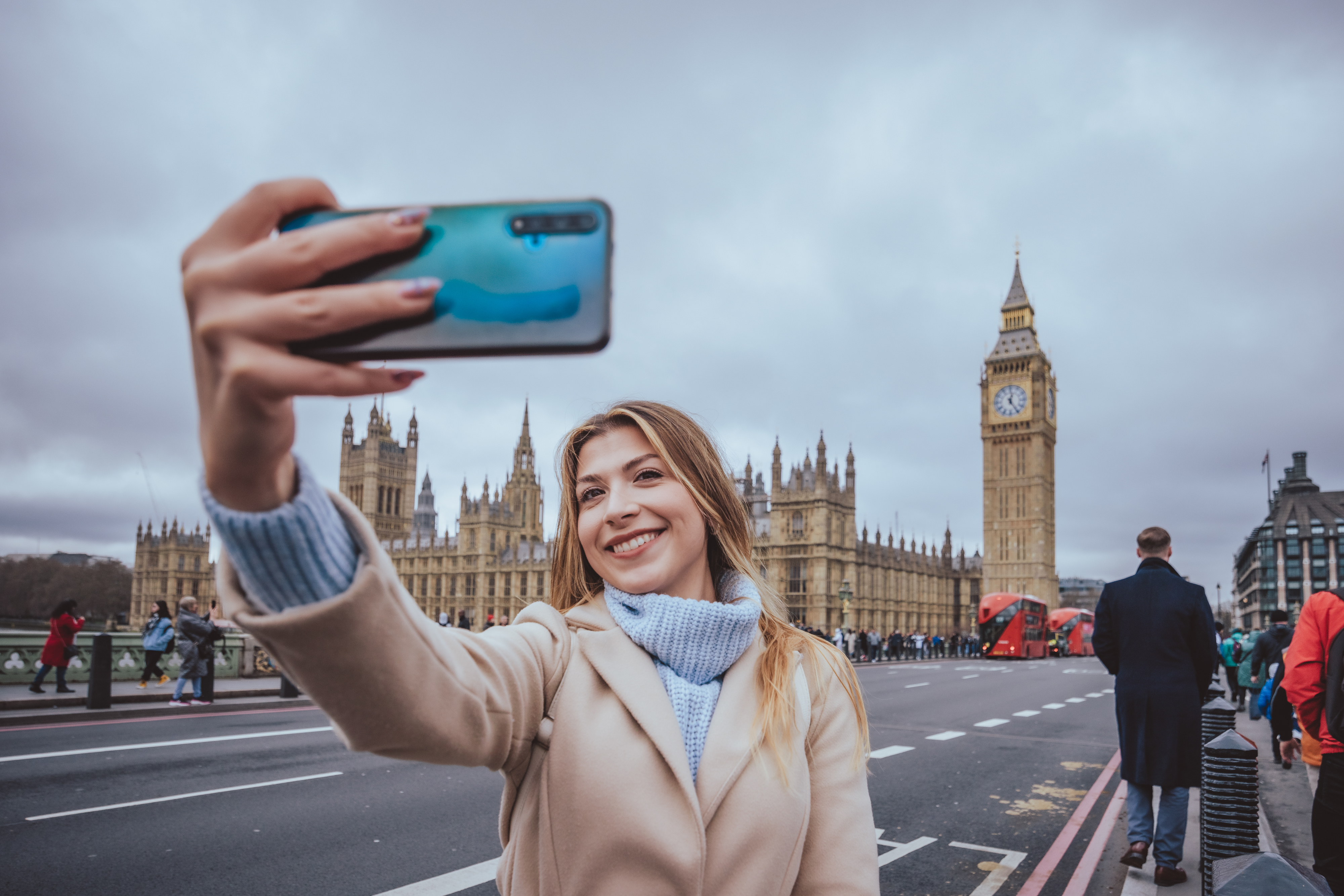 Woman takes a selfie with Big Ben and the UK Parliament in the background
