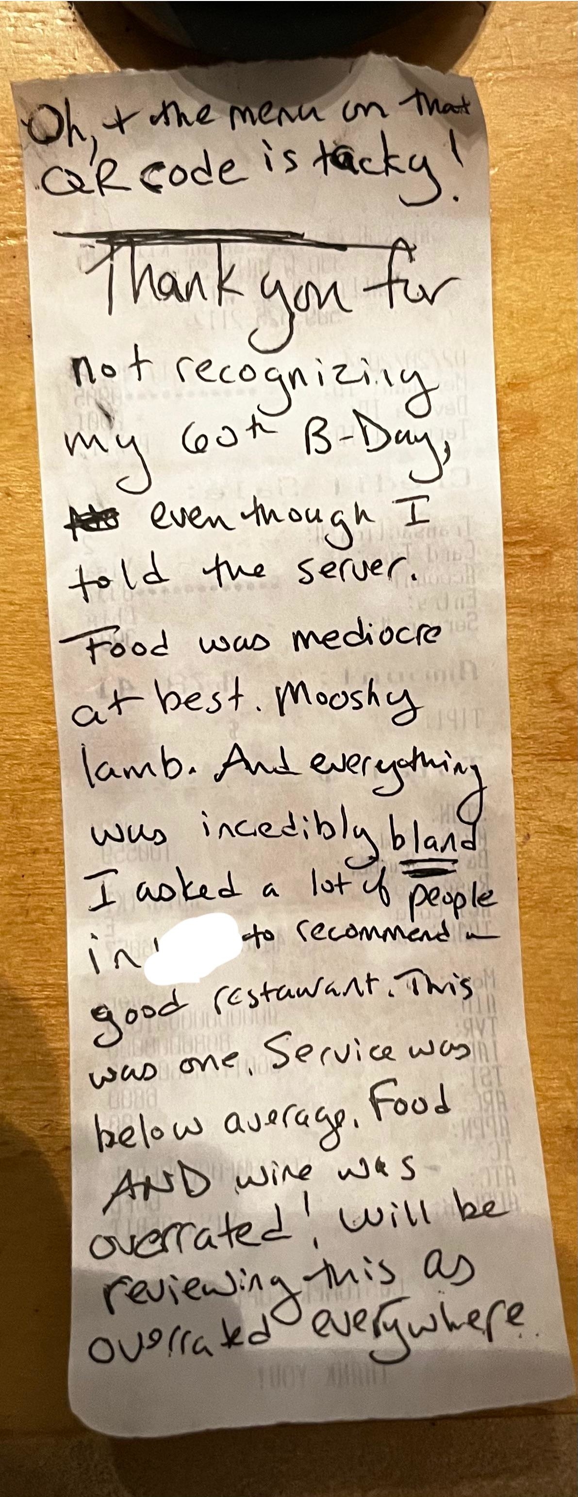 Note left on a table expressing dissatisfaction with a meal, mentioning overcooked lamb and overall negative dining experience