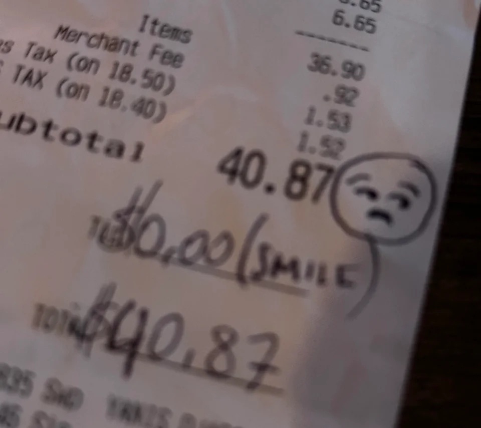 Receipt with handwritten note, total of $40.87, and a drawn unhappy face with word &quot;SMILE&quot;