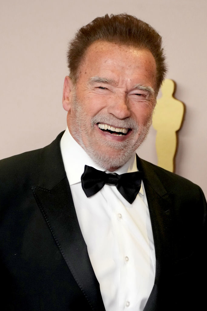 Smiling man in a black suit and bow tie at an event