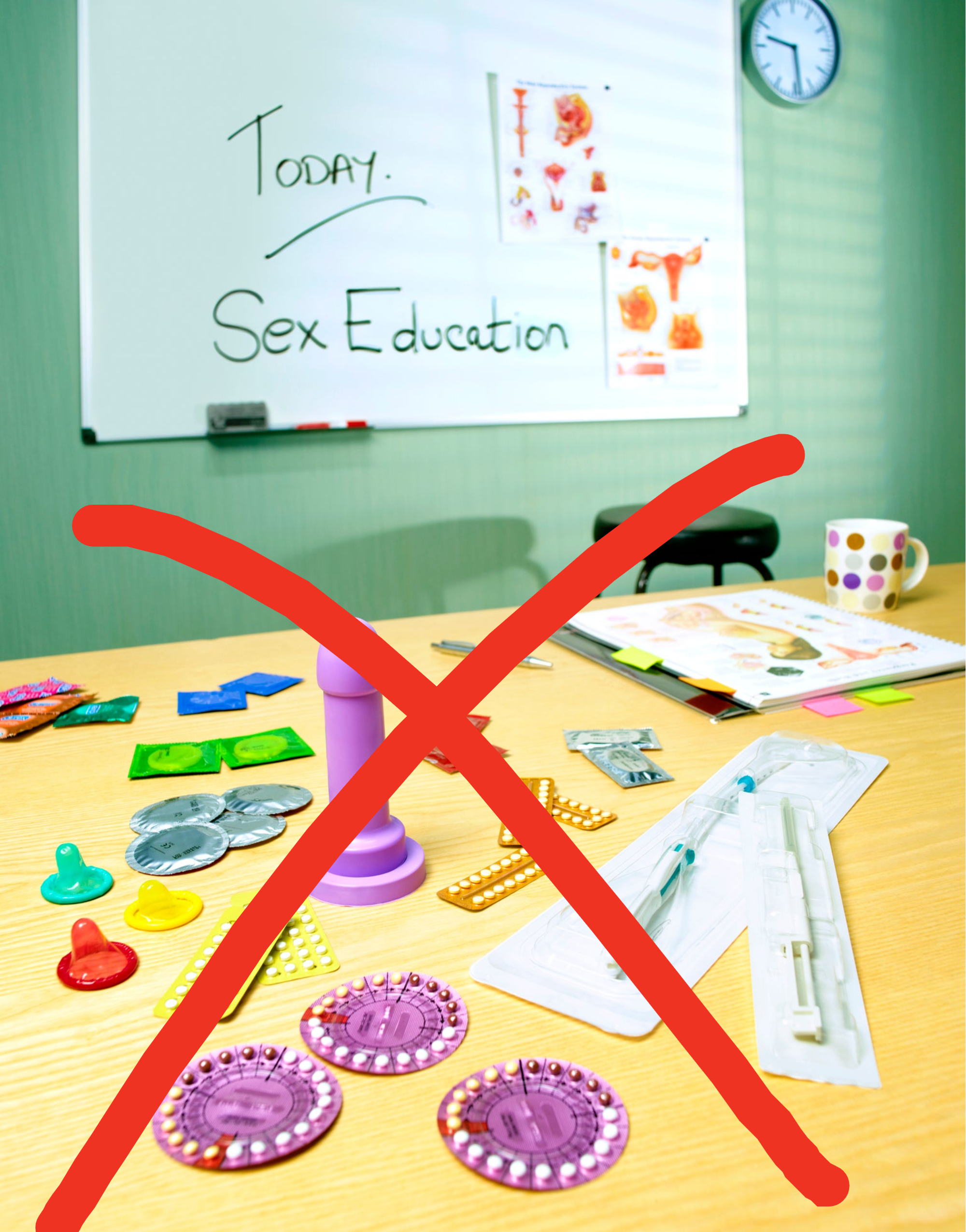 A classroom setting with sex education materials, including contraceptives and diagrams, on a desk