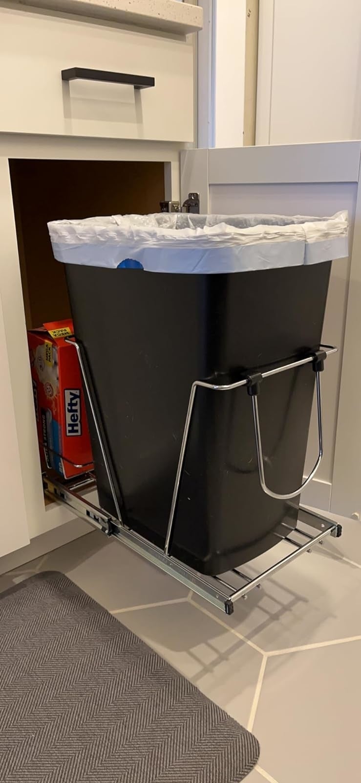 reviewer's slide-out trash can pulled out from the cabinet