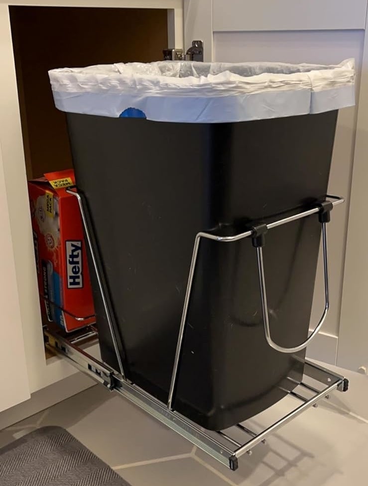 reviewer&#x27;s slide-out trash can pulled out from the cabinet