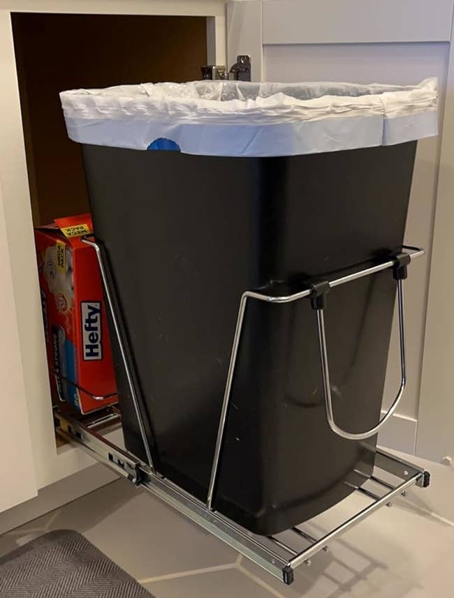 reviewer's slide-out trash can pulled out from the cabinet