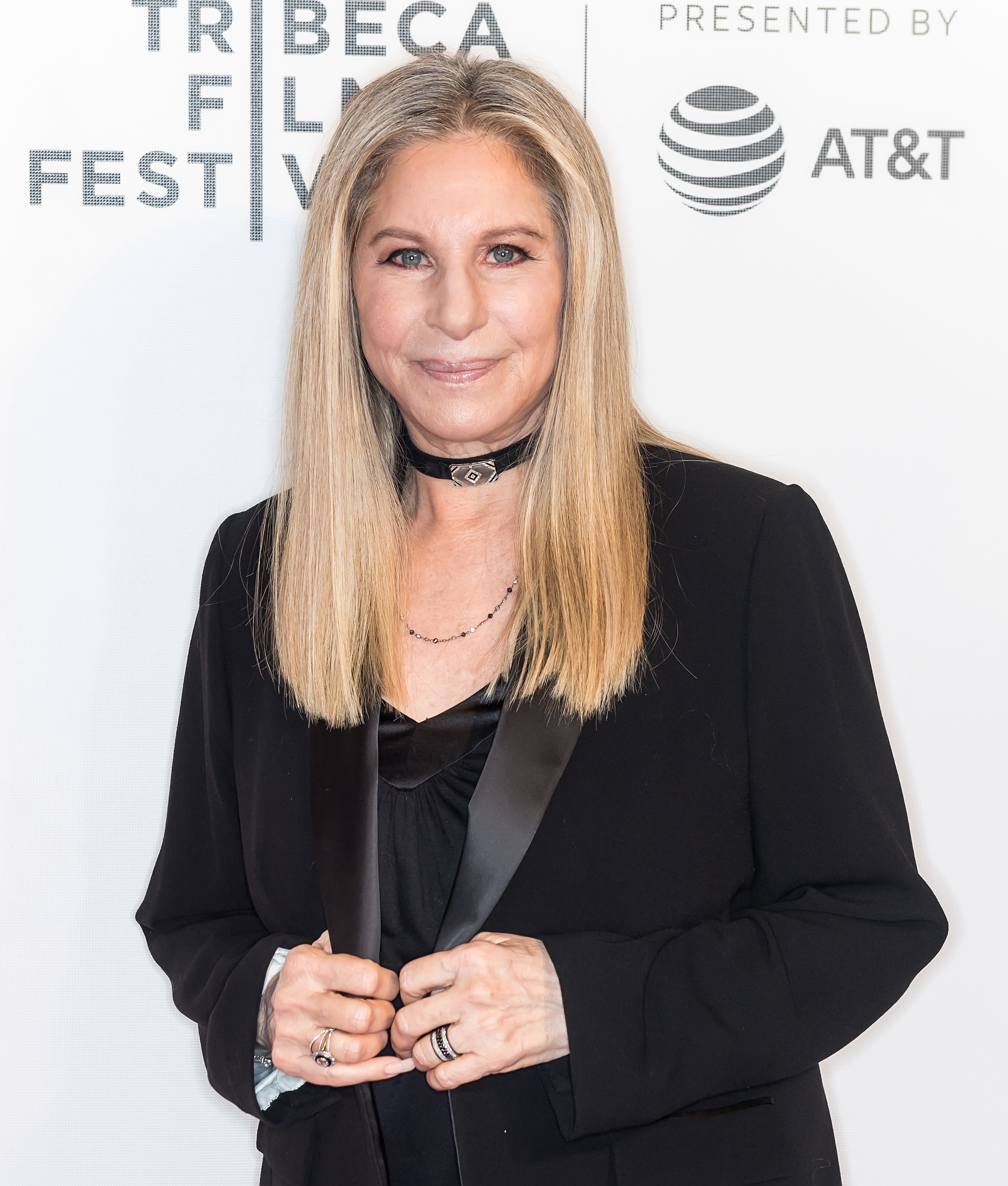 Barbra Streisand wearing a black outfit with necklace, posing at the Tribeca Film Festival