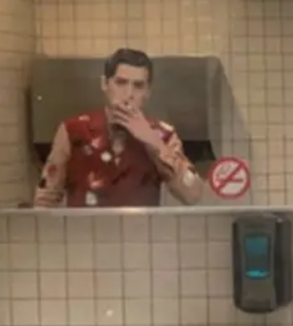 Cole smoking in the bathroom mirror