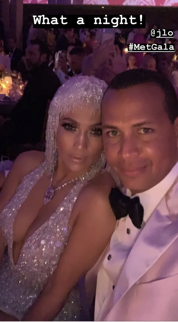 Jennifer Lopez in a sparkly dress with Alex Rodriguez in a tuxedo at an event