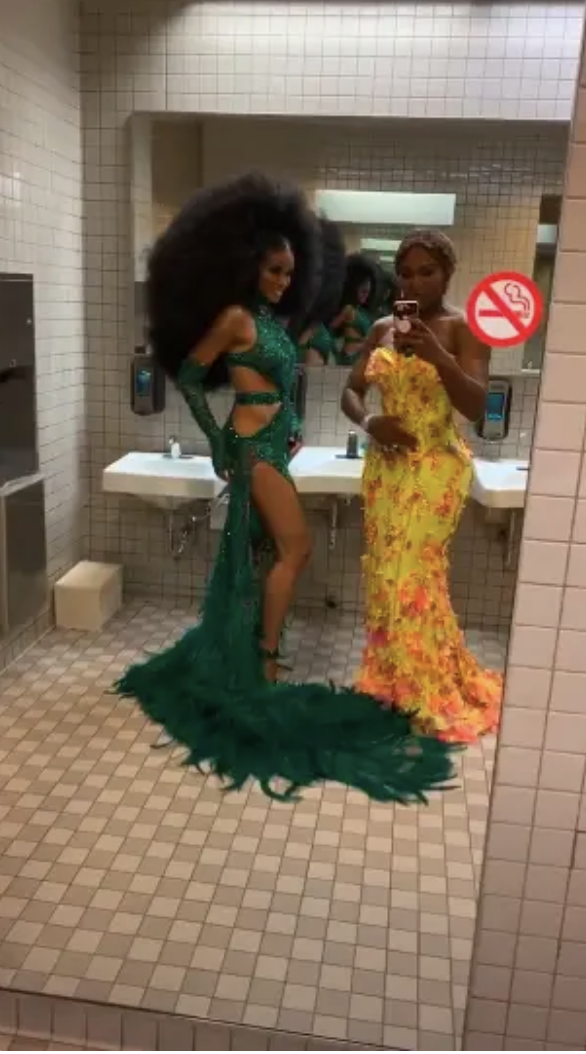 Serena and Ciara posing in restroom, in fancy gowns