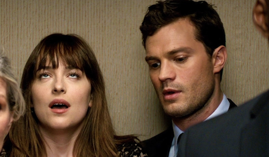 Anastasia Steele and Christian Grey look surprised in a scene from &quot;Fifty Shades of Grey&quot;