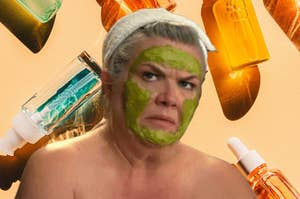 Person looking disgruntle with a facial mask surrounded by skincare products