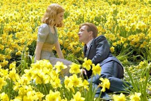 Two characters from the film 'Big Fish' are having a conversation in a field of daffodils