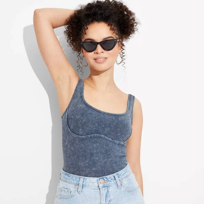 model in the sleeveless bust seam crop top in blue