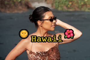 Kourtney Kardashian in sunglasses looks away with sun and flower emojis, and "Hawaii" text overlay