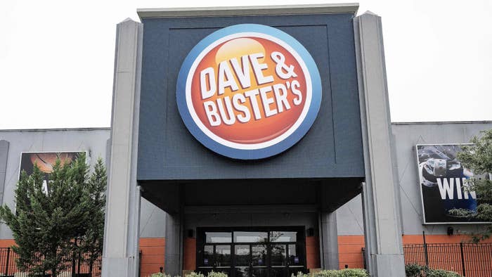 Dave &amp; Buster&#x27;s restaurant entrance with company logo sign above doors