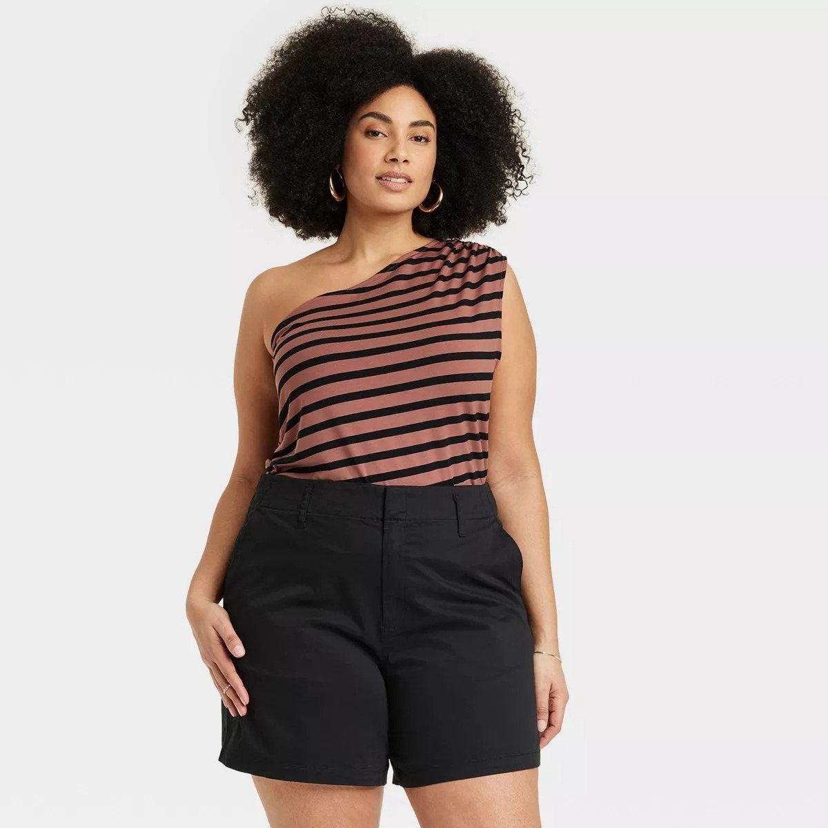 Model in the one-shoulder top in brown with black stripes
