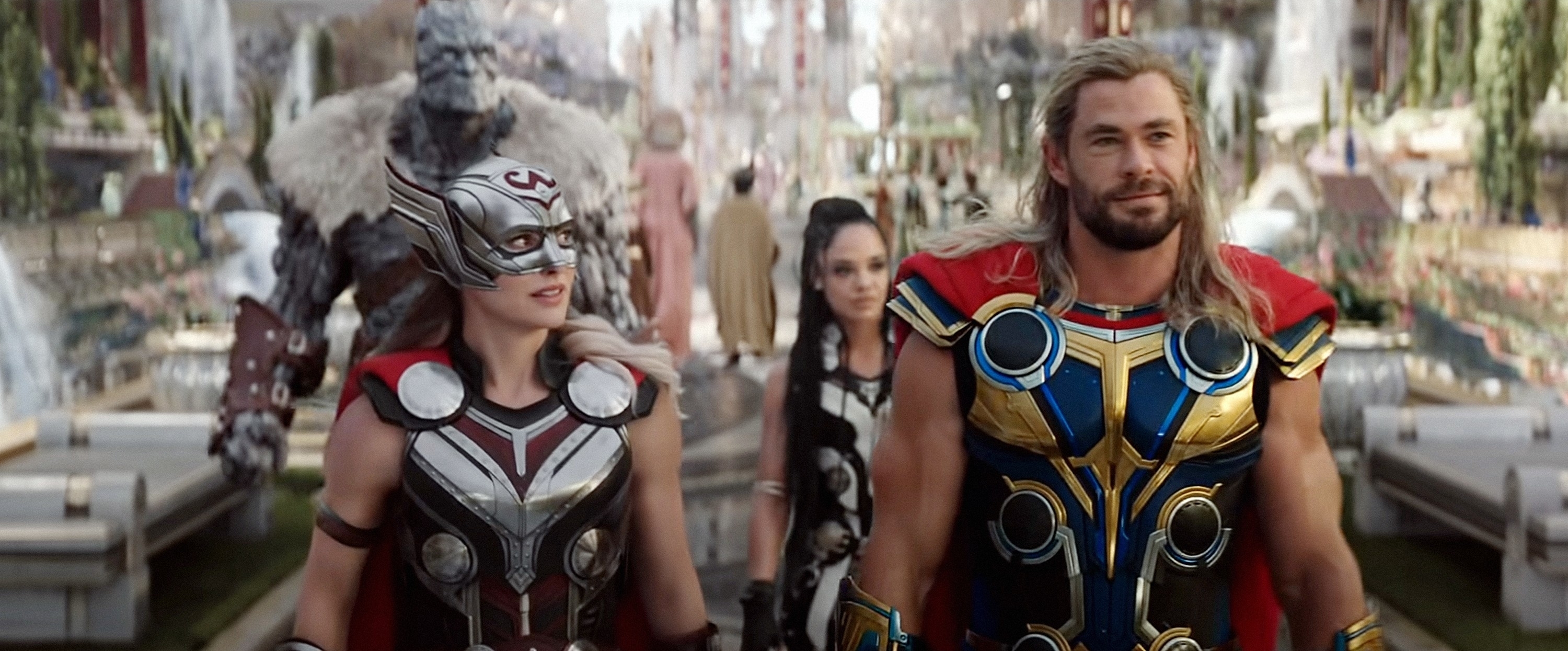 Mighty Thor and Thor walking confidently in Asgard, with Valkyrie and Korg in the background. They wear their superhero costumes
