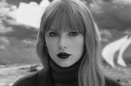 Black and white photo of Taylor Swift with a turtleneck and bold lipstick, looking at the camera