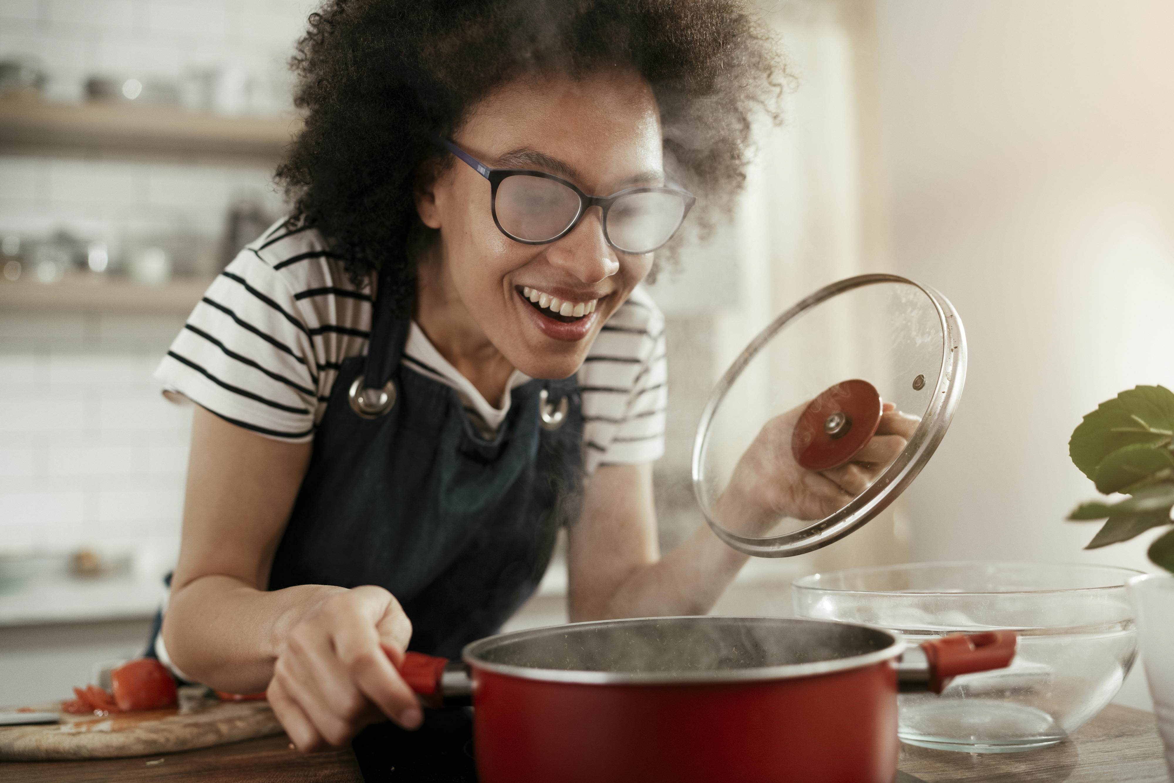 Woman making soup in her home kitchen