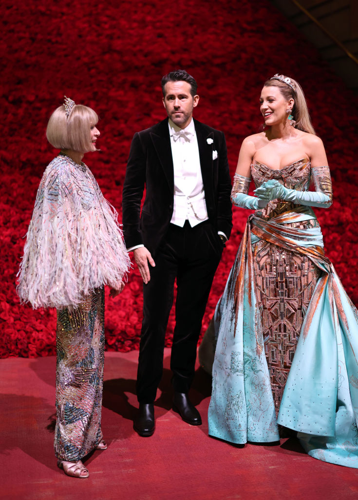 Anna Wintour in a textured outfit, Ryan Reynolds in a tuxedo, and Blake Lively in a dress with a metallic corset and a pastel train