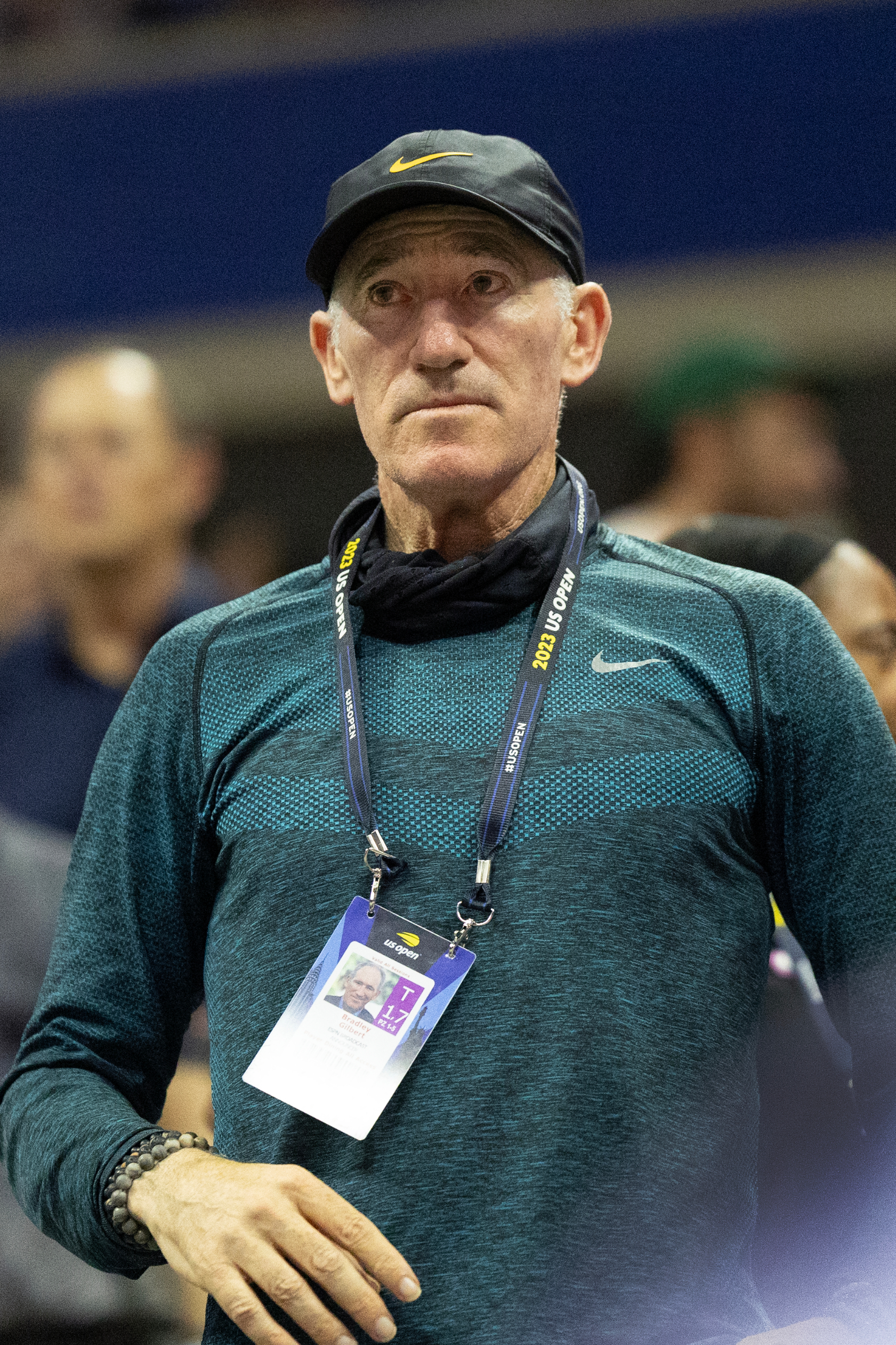 Brad Gilbert with cap and lanyard standing in a crowded area