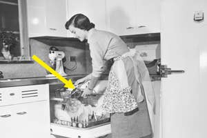 Woman loading dishes into an old-fashioned dishwasher, kitchen retro style