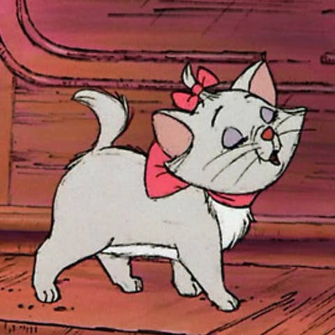 Animated kitten with a pink bow walking across a wooden floor