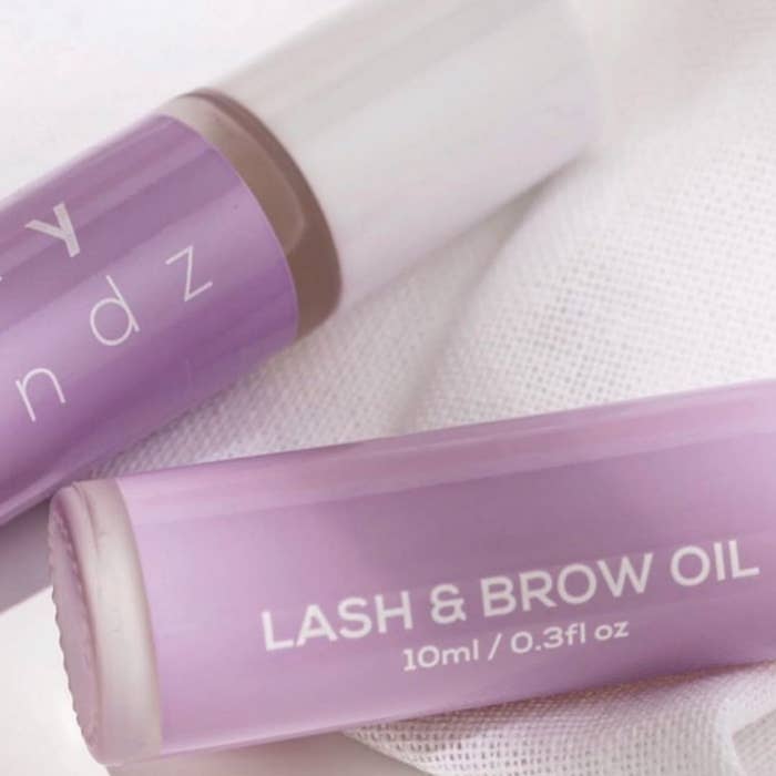 Two containers of lash and brow oil, 10ml size, with branding partially visible