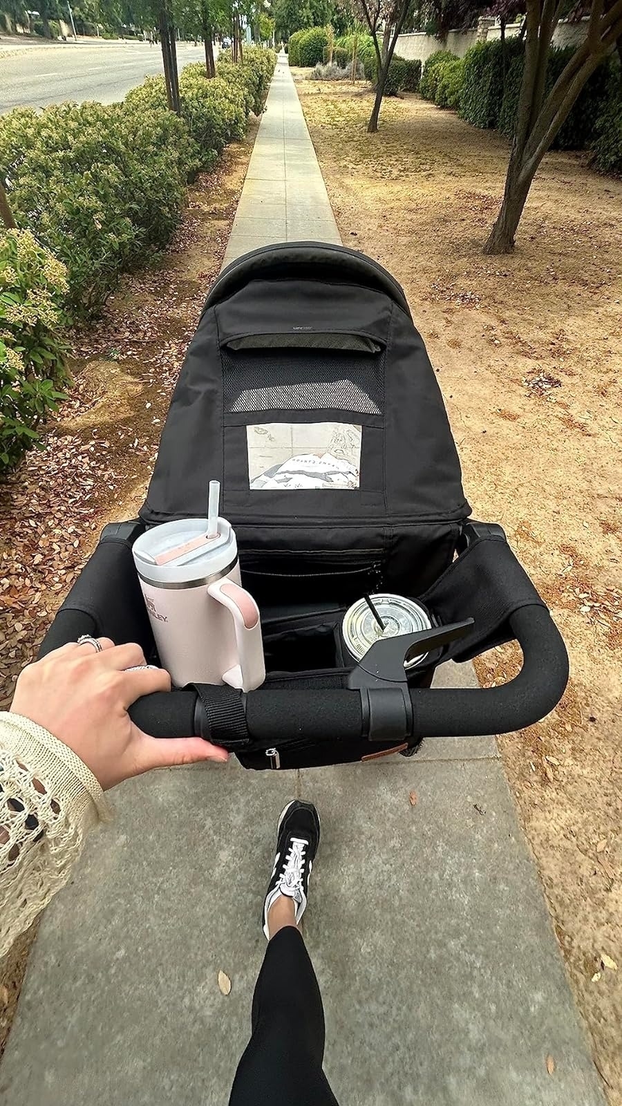reviewer&#x27;s view of stroller organizer with Stanley cup storage pocket