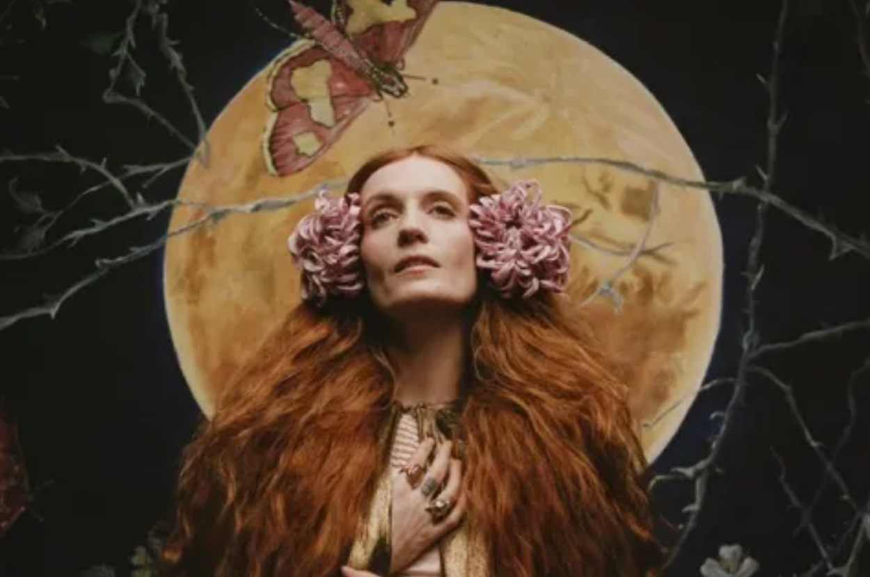 Florence with floral adornments, hands clasped, with a full moon and butterflies backdrop