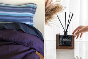 A hand adjusting a wood-scented reed diffuser beside a striped pillow and dark bedding on a sunny window ledge