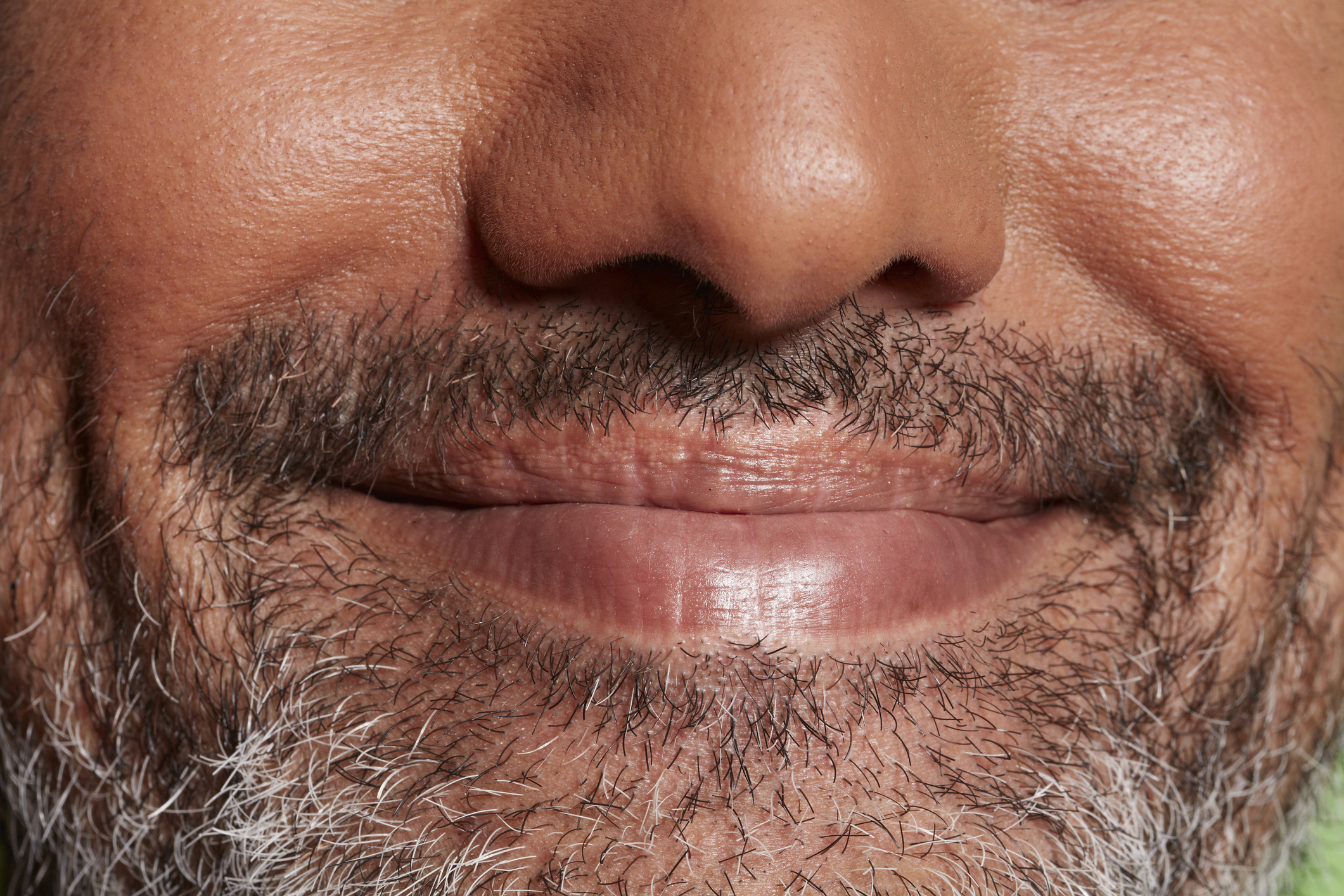 Close-up of a person&#x27;s smile with a mustache, no identification possible