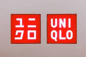 Two Uniqlo brand logo signs displayed on a wall