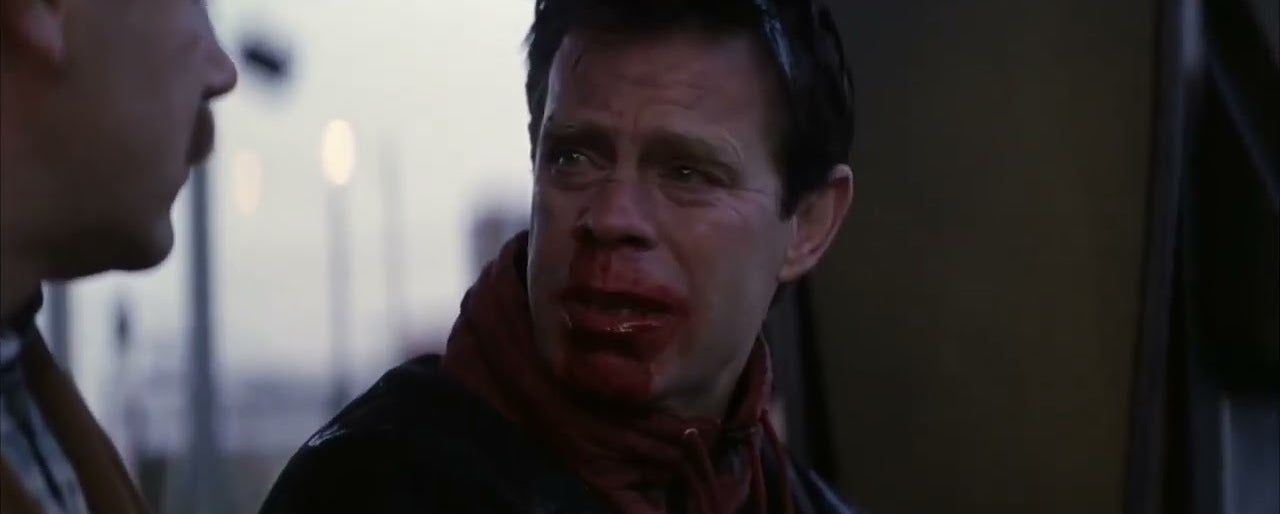 Brad Pitt with blood on his face, expressing distress, in a scene from a movie