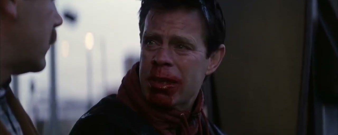 Brad Pitt with blood on his face, expressing distress, in a scene from a movie